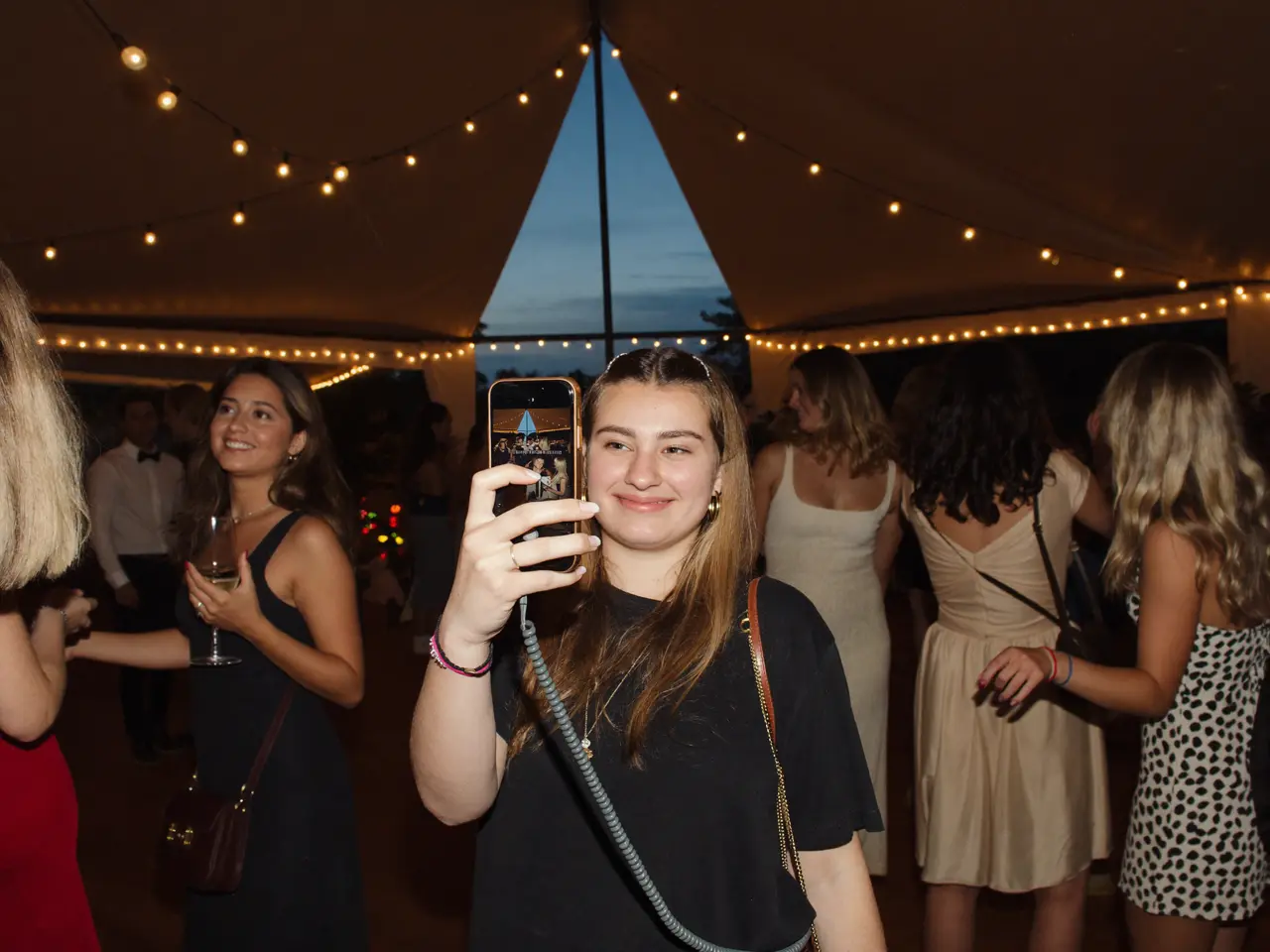 A guest filming the dance floor on her phone