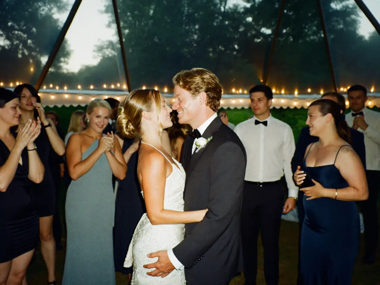 A first dance in a marquee under festoon lights